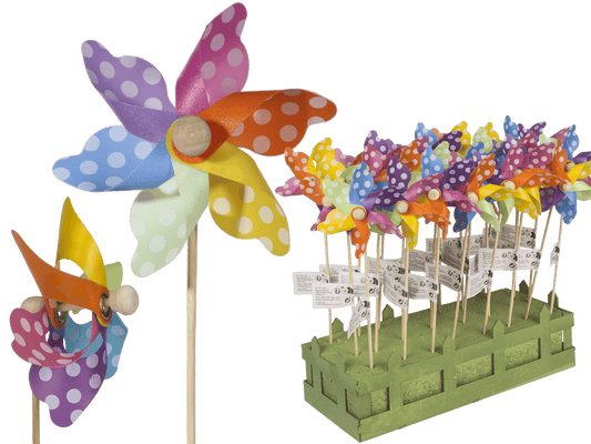 Multicoloured windmilll with white dots on wooden,