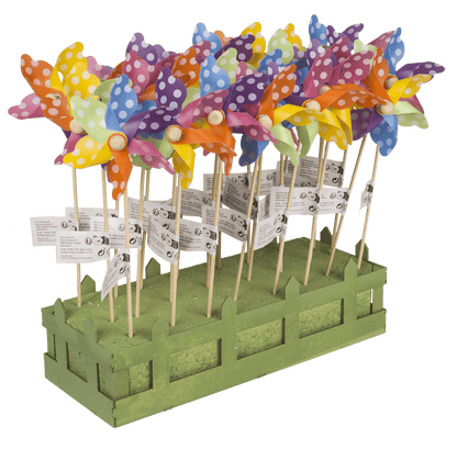 Multicoloured windmilll with white dots on wooden,