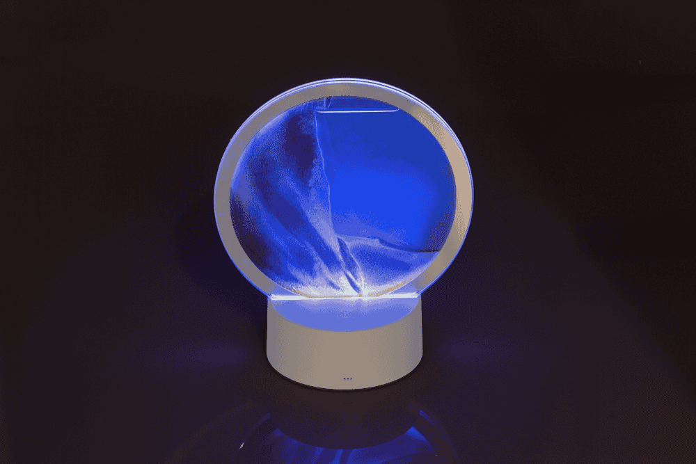 Rotating sand picture, with colour-changing LED
