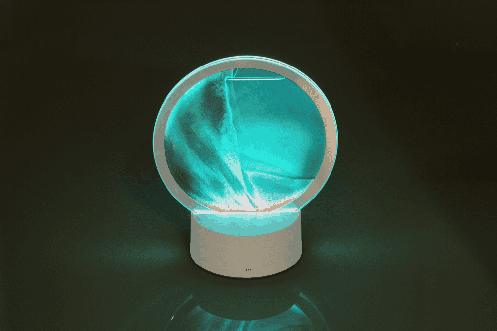 Rotating sand picture, with colour-changing LED