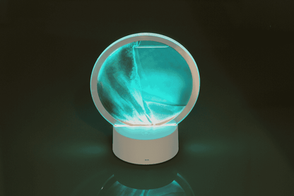 Rotating sand picture, with colour-changing LED