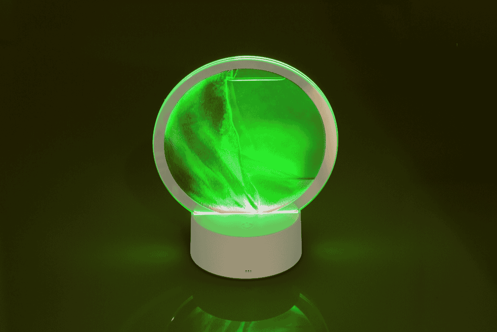 Rotating sand picture, with colour-changing LED