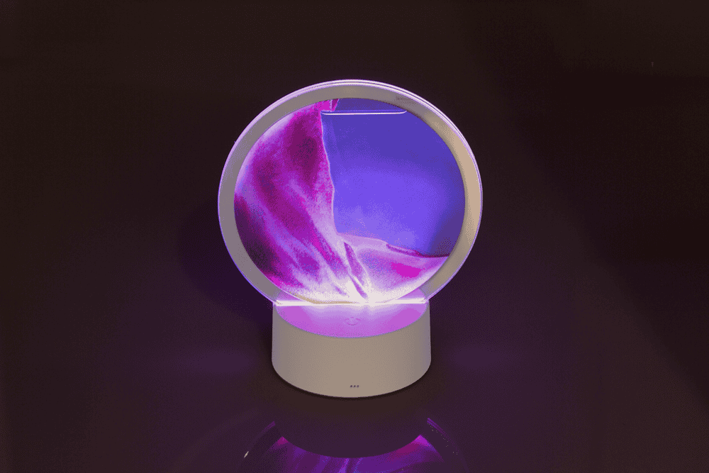 Rotating sand picture, with colour-changing LED